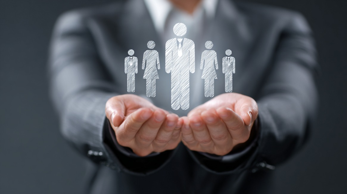 Business leader holding icons representing a team
